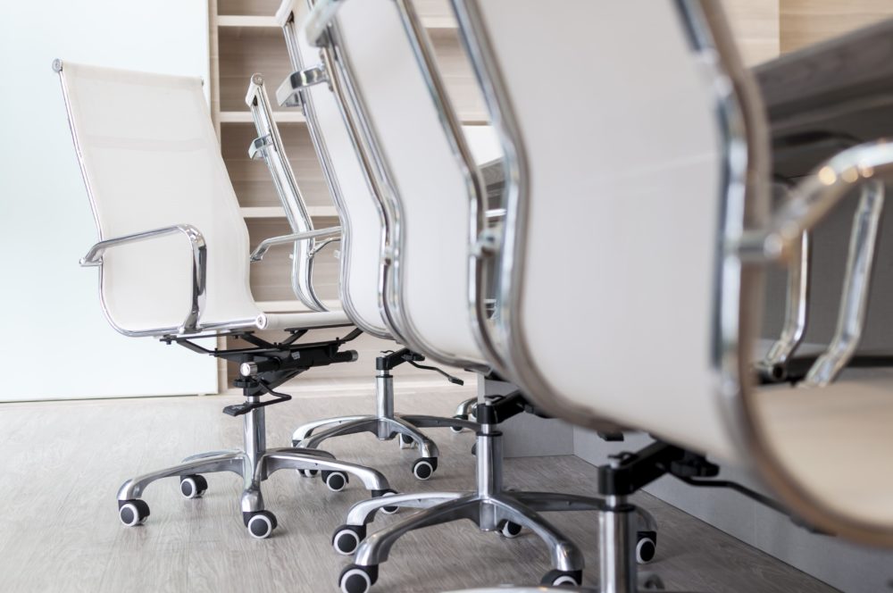 Office chairs lined up by a table