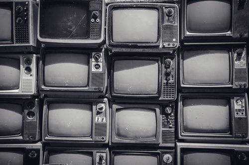 Old TVs stacked on top of one another