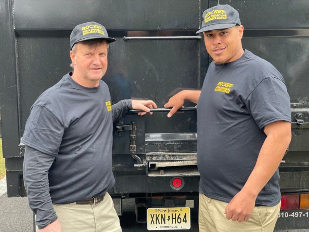 rocket junk employees in front of truck