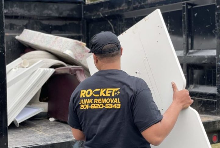 junk removal pro hauling mattress into truck