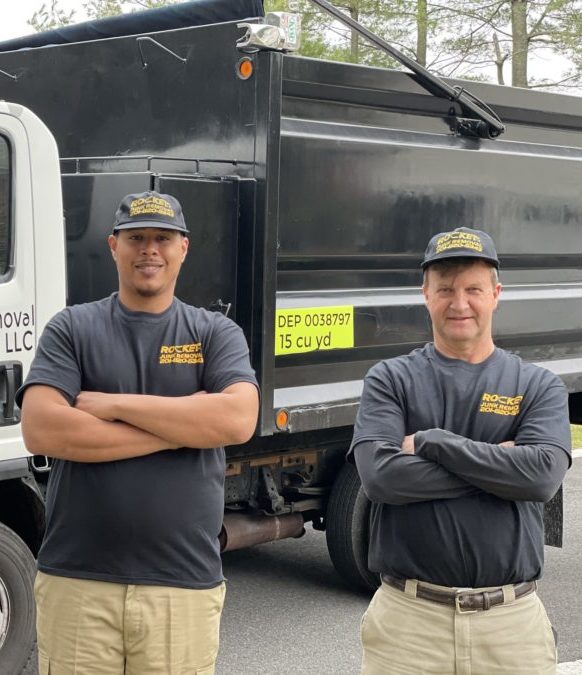 junk removal pros standing in front of rocket junk removal truck
