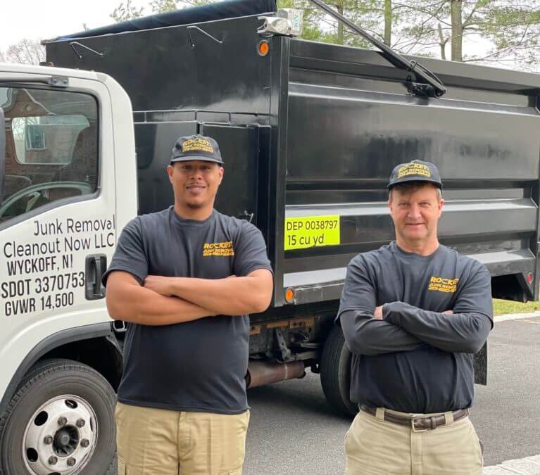 junk removal pros standing in front of rocket junk removal