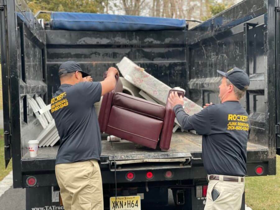 rocket junk removal crew hauling junk into truck