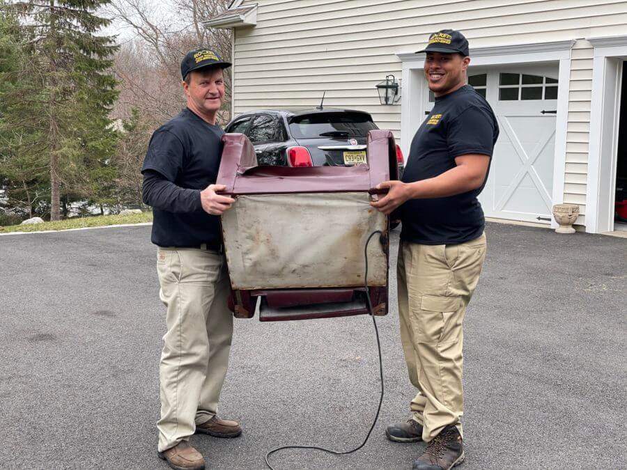 rocket junk removal pros carrying chair